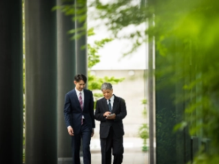 Colleagues strolling in greenery