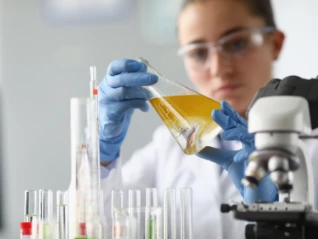 woman chemist scientist holding flask at hand