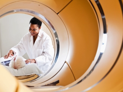 healthcare professional assisting a patient undergoing an mri scan