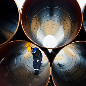 Worker inside industrial pipes