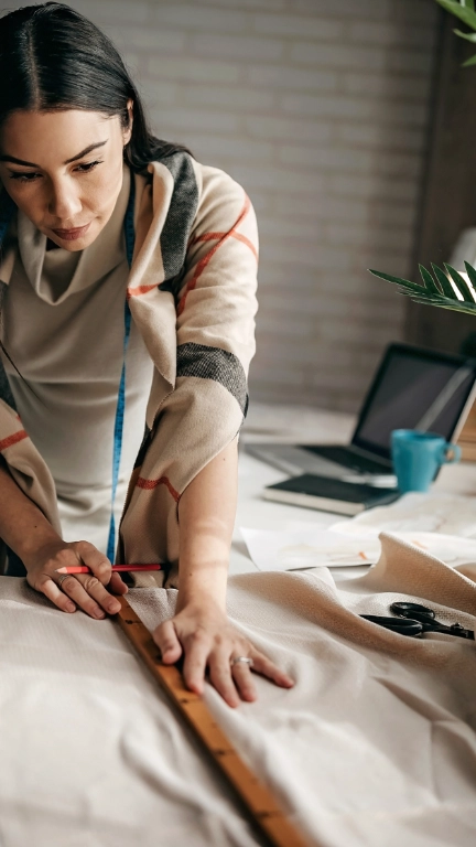 female textile worker cutting fabric seamstress