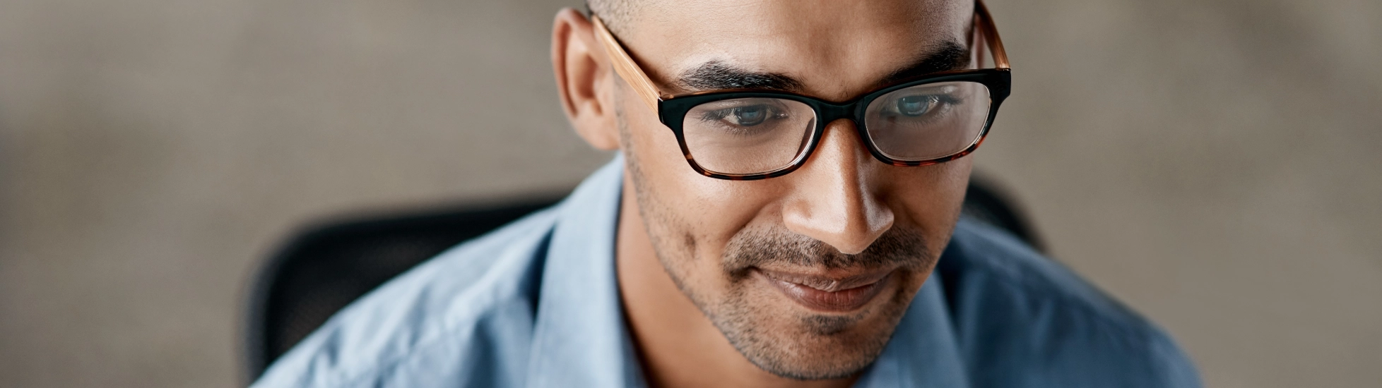 ethnic IT man studying his computer screen