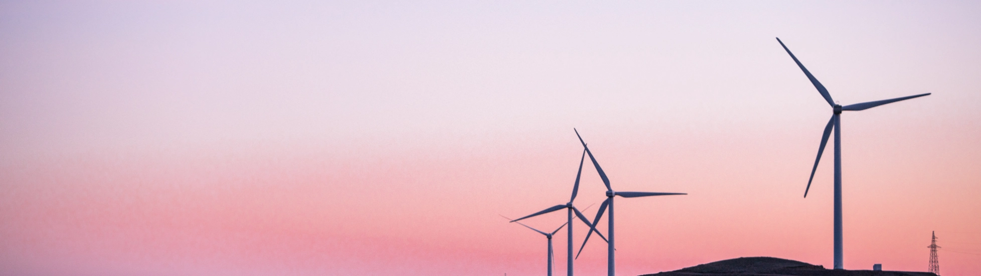 Wind turbines on a hillside at dusk