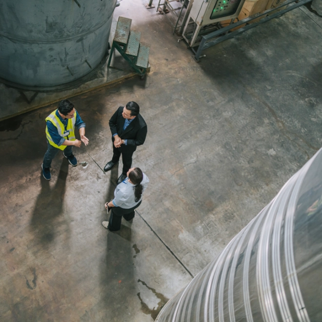 Workers having a discussion in a large warehouse