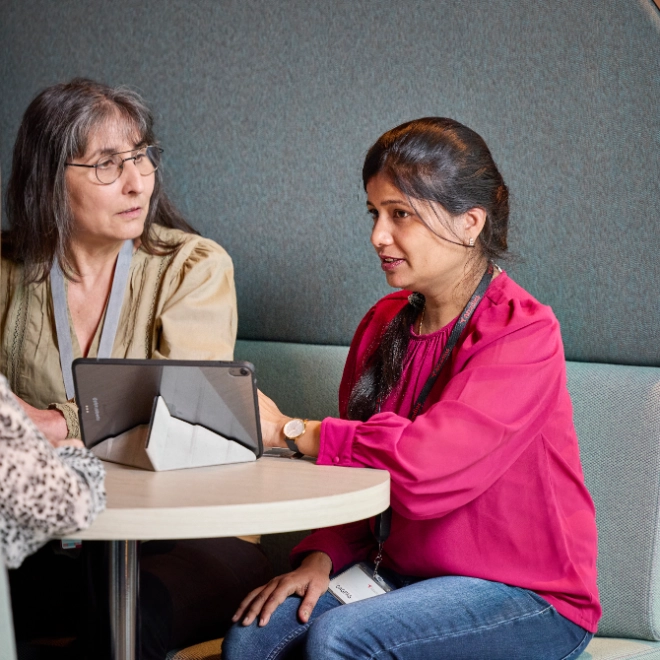 Two Atradius colleagues working in a breakout area