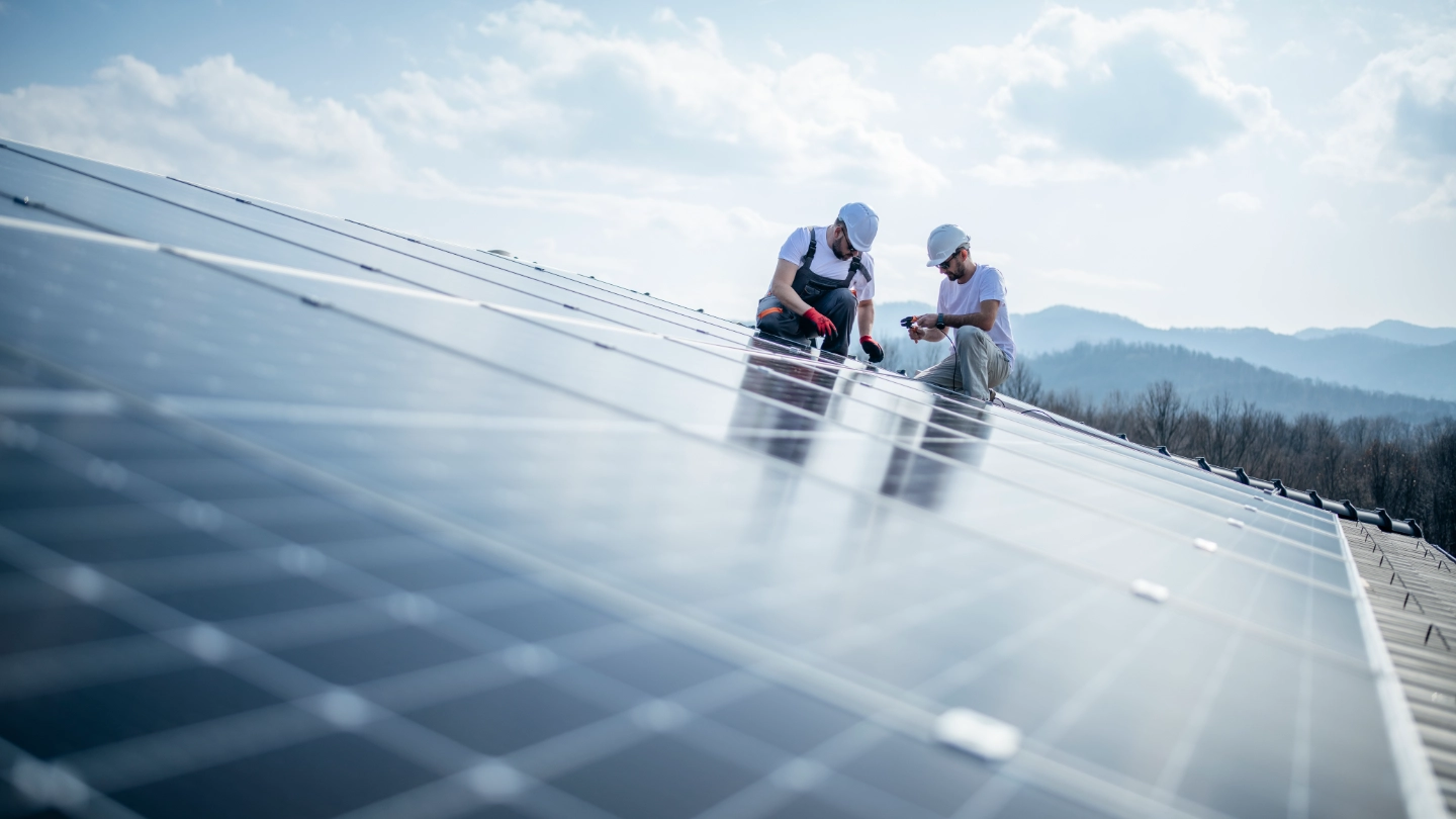 Two engineers installing solar panels image